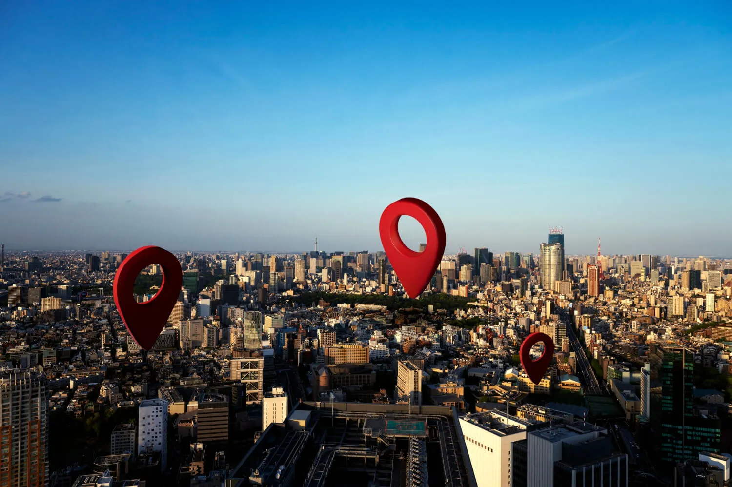 Red map pins over a city skyline, marking the branches of a multi-location retail business